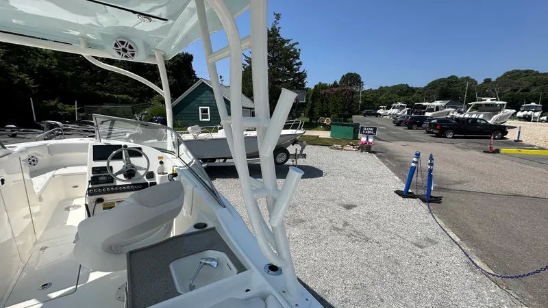 Slide: The Image of 2026 Key West 239 DFS boat at a marina with parked cars and boats. - 18