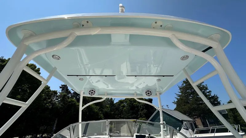 Slide: The Image of 2026 Key West 239 DFS boat with sleek canopy design under clear blue sky. - 20