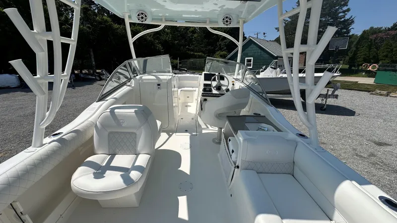 Slide: The Image of 2026 Key West 239 DFS boat interior with white seating and steering console. - 21