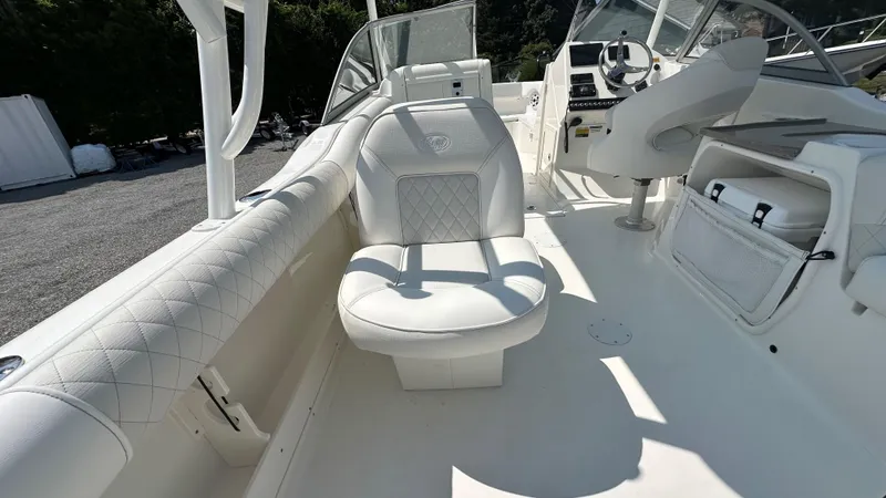 Slide: The Image of 2026 Key West 239 DFS boat interior with white seating and modern dashboard. - 22