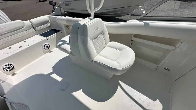 Slide: The Image of 2026 Key West 239 DFS boat interior with white seating and speakers. - 23