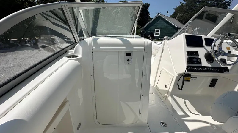 Slide: The Image of 2026 Key West 239 DFS boat interior with steering console and seating area. - 24