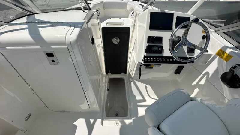 Slide: The Image of 2026 Key West 239 DFS boat interior with steering wheel and control panel. - 28