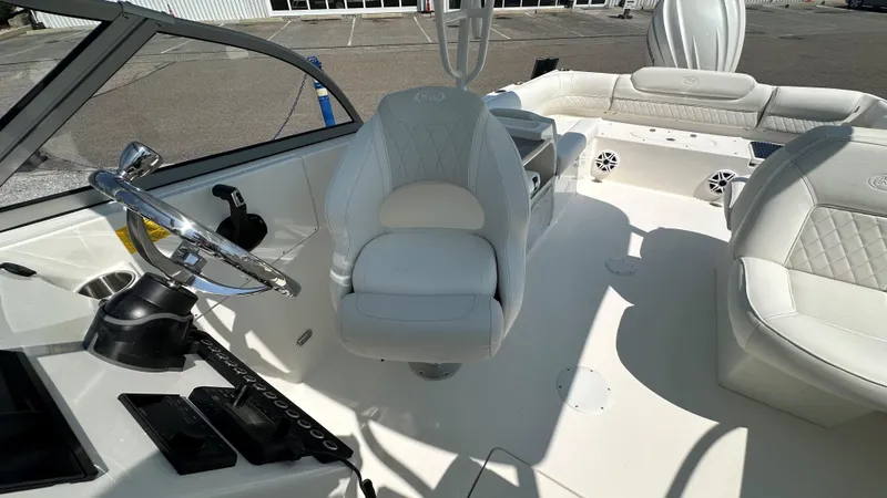Slide: The Image of Interior of 2026 Key West 239 DFS boat with white seating and steering wheel. - 29