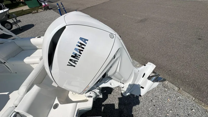 Slide: The Image of 2026 Key West 239 DFS boat with Yamaha outboard motor, parked on pavement. - 3
