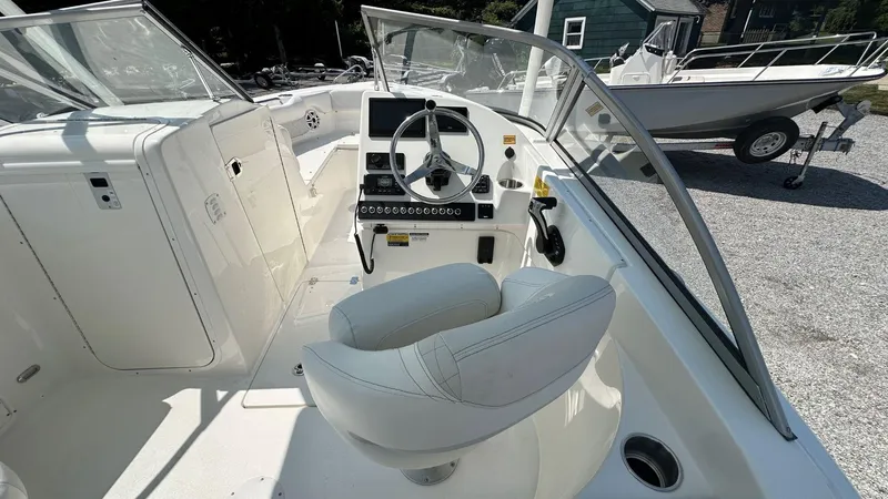 Slide: The Image of 2026 Key West 239 DFS boat interior with steering wheel and seating. - 30