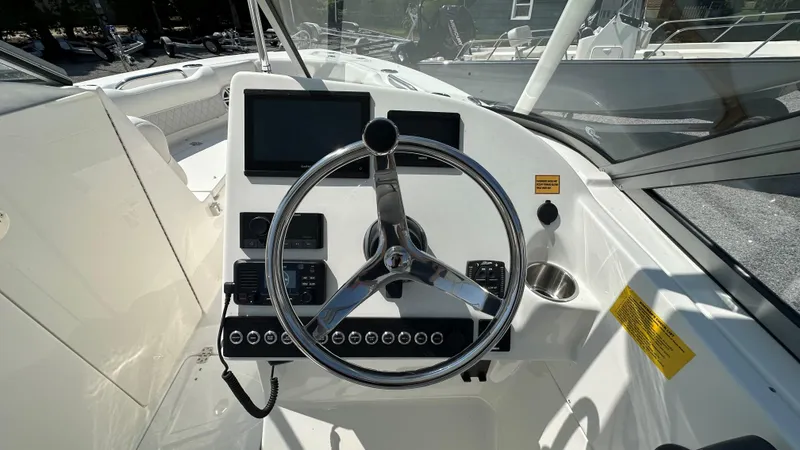 Slide: The Image of 2026 Key West 239 DFS boat dashboard with steering wheel and control panel. - 31