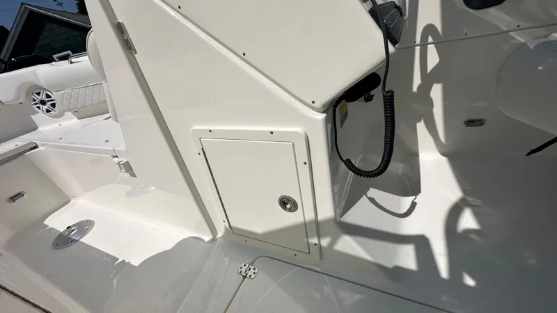 Slide: The Image of Interior view of 2026 Key West 239 DFS boat, featuring white seating and storage compartments. - 32