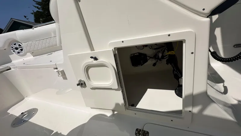 Slide: The Image of 2026 Key West 239 DFS boat interior storage compartment with open hatch. - 33