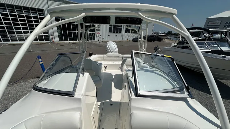 Slide: The Image of 2026 Key West 239 DFS boat interior with open windshield, docked at marina. - 34