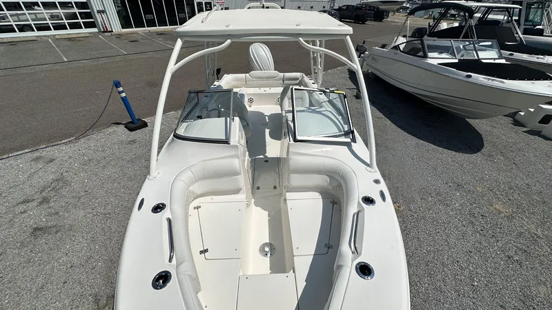 Slide: The Image of 2026 Key West 239 DFS boat with open deck and seating, displayed outdoors. - 35