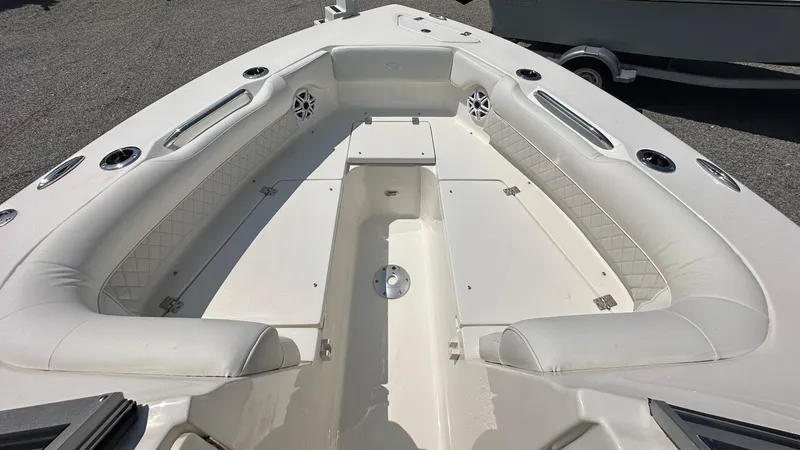 Slide: The Image of 2026 Key West 239 DFS boat interior with cushioned seating and storage compartments. - 36