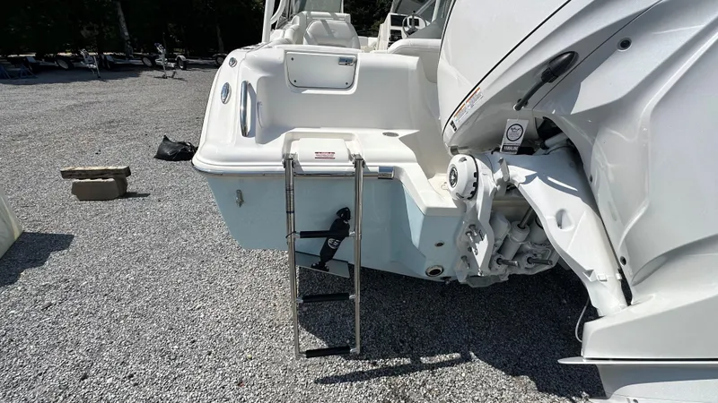 Slide: The Image of 2026 Key West 239 DFS boat with ladder on gravel surface. - 4