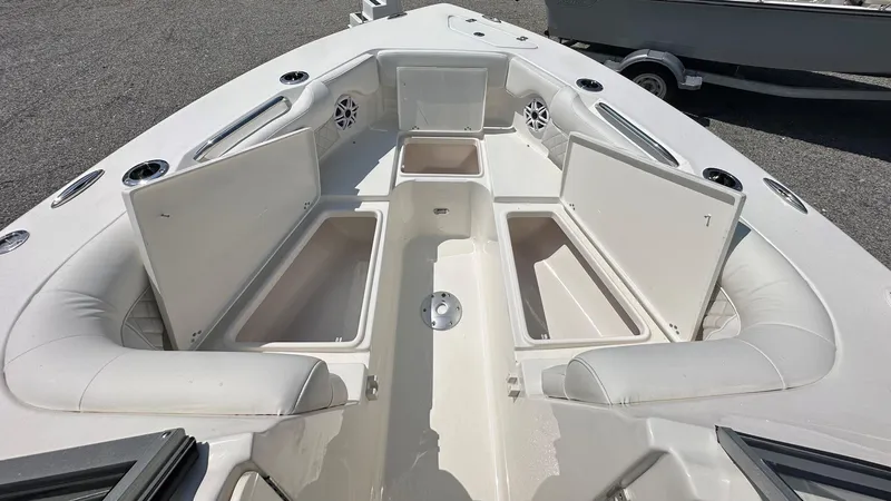 Slide: The Image of 2026 Key West 239 DFS boat interior with open storage compartments and cushioned seating. - 40