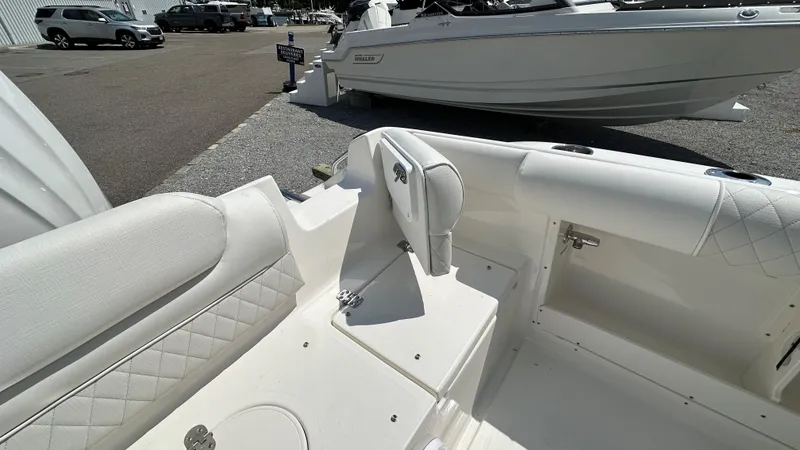 Slide: The Image of 2026 Key West 239 DFS boat interior with white seating and storage compartments. - 6