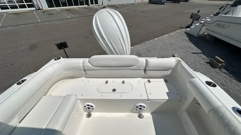 Slide: The Image of 2026 Key West 239 DFS boat interior with white seating and speakers. - 8