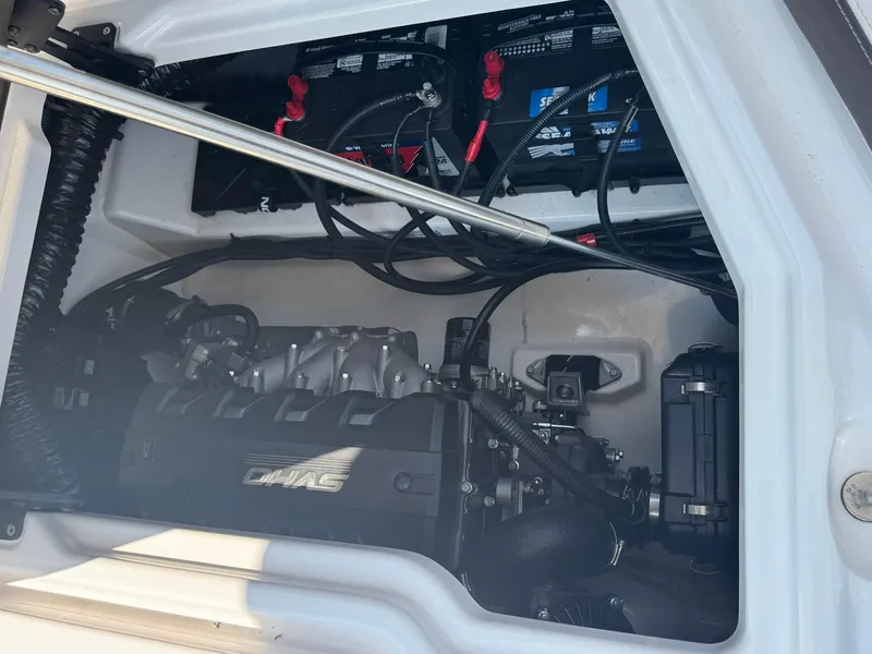 Slide: The Image of Engine compartment of a 2022 Yamaha Boats 275SD, showcasing internal components and wiring. - 14