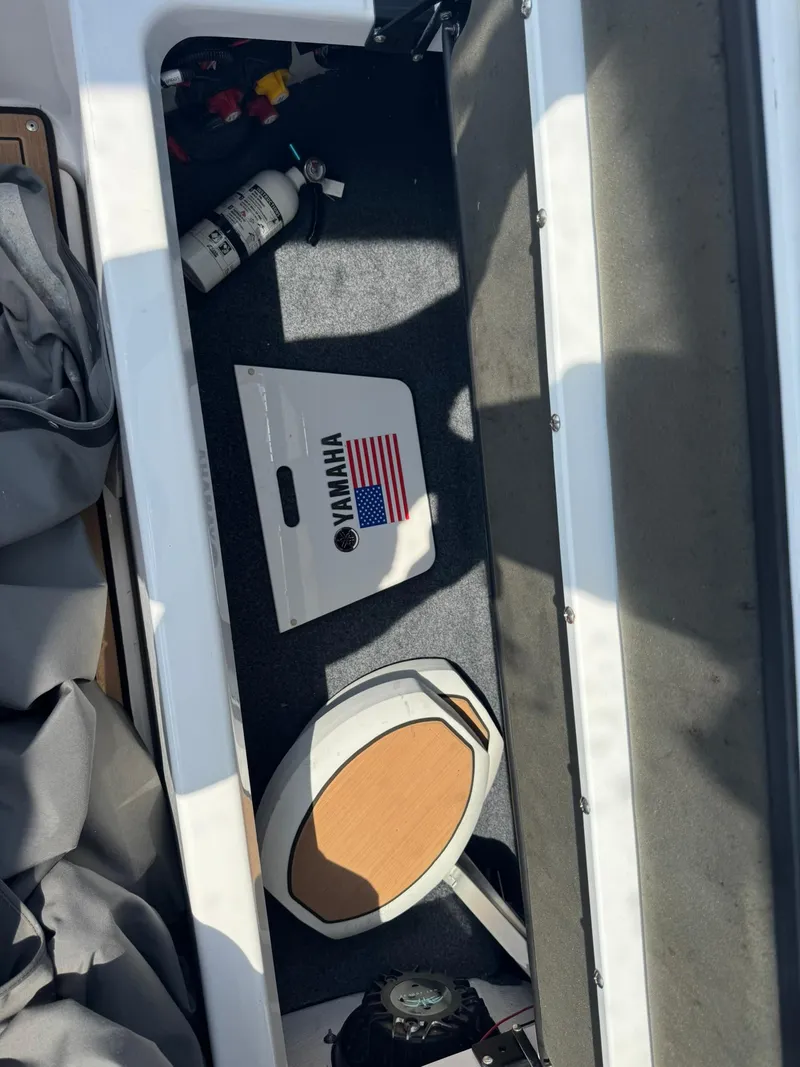 Slide: The Image of Storage compartment of 2022 Yamaha Boats 275SD with equipment and accessories. - 21