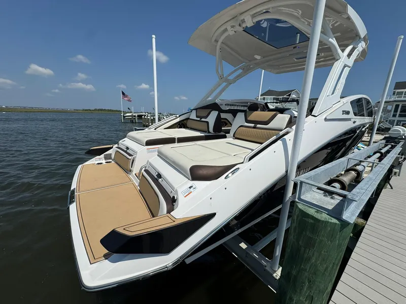 Slide: The Image of 2022 Yamaha Boats 275SD docked, showcasing sleek design and spacious seating. - 3