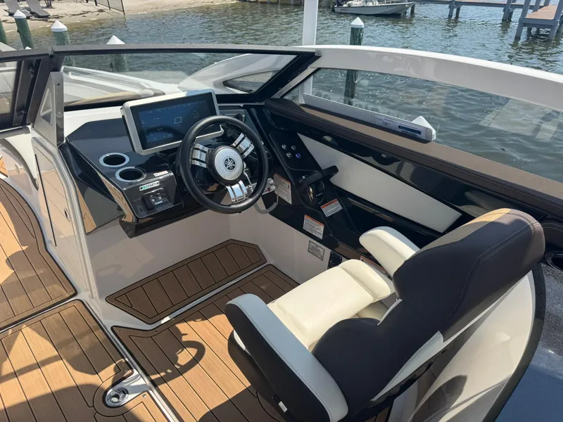 Slide: The Image of 2022 Yamaha Boats 275SD helm with modern controls and luxurious seating. - 6