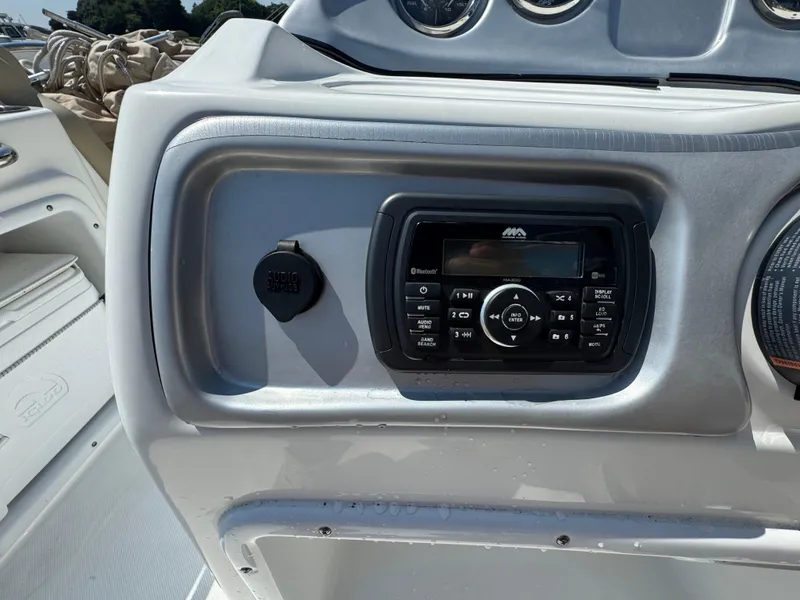 Slide: The Image of 2017 Hurricane SunDeck Sport 203 OB boat dashboard with audio system and controls. - 12