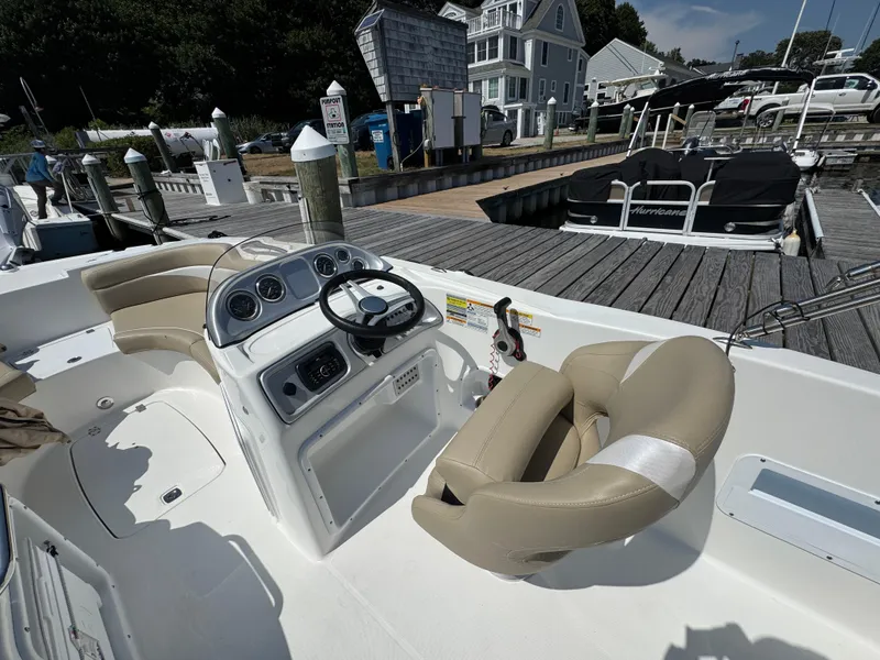 Slide: The Image of 2017 Hurricane SunDeck Sport 203 OB boat interior at marina dock. - 13