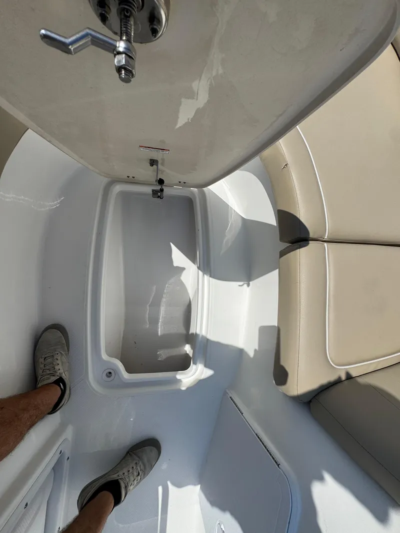 Slide: The Image of Interior view of 2017 Hurricane SunDeck Sport 203 OB boat with seating and storage. - 16