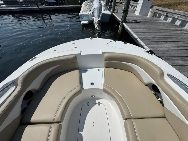 Slide: The Image of 2017 Hurricane SunDeck Sport 203 OB boat with beige seating at a dock. - 17