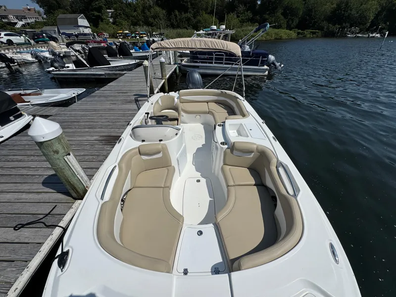 Slide: The Image of 2017 Hurricane SunDeck Sport 203 OB boat docked at marina, featuring spacious seating. - 22