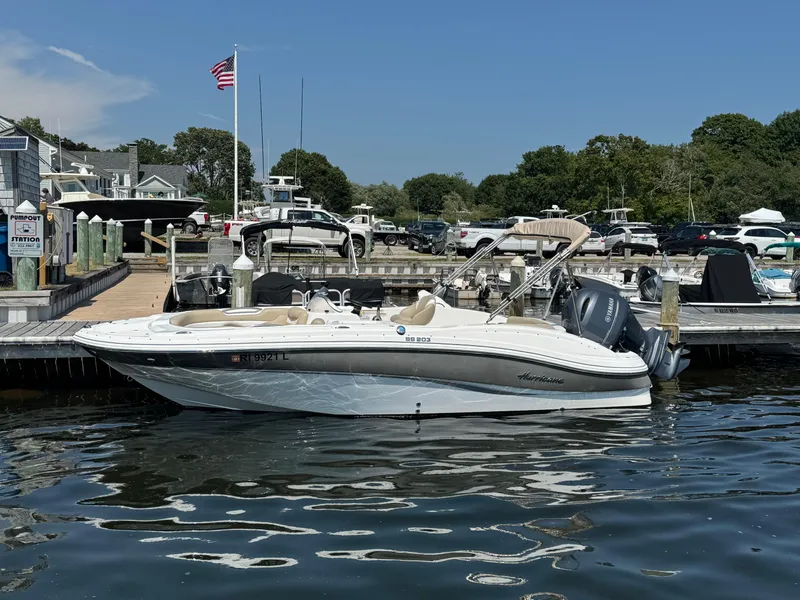 Slide: The Image of 2017 Hurricane SunDeck Sport 203 OB boat docked at a marina under clear blue skies. - 3