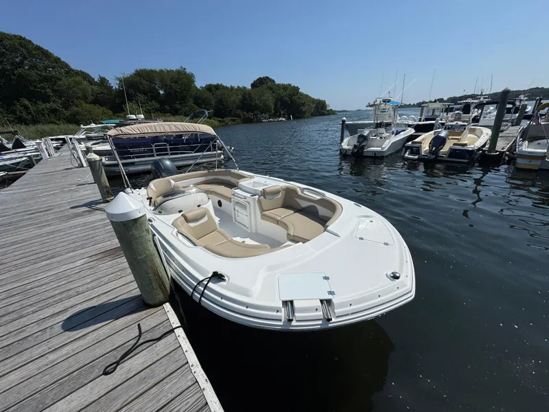 Slide: The Image of 2017 Hurricane SunDeck Sport 203 OB docked at a marina, surrounded by other boats. - 4