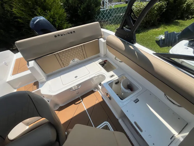 Slide: The Image of 2023 Bayliner DX 2000 boat interior with seating and storage compartments. - 10