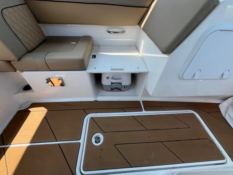 Slide: The Image of Interior of 2023 Bayliner DX 2000 boat with cushioned seating and storage compartment. - 17