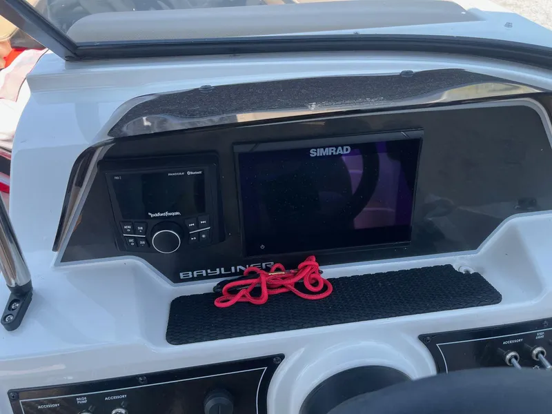 Slide: The Image of 2023 Bayliner DX 2000 dashboard with Simrad display and Rockford Fosgate audio system. - 18
