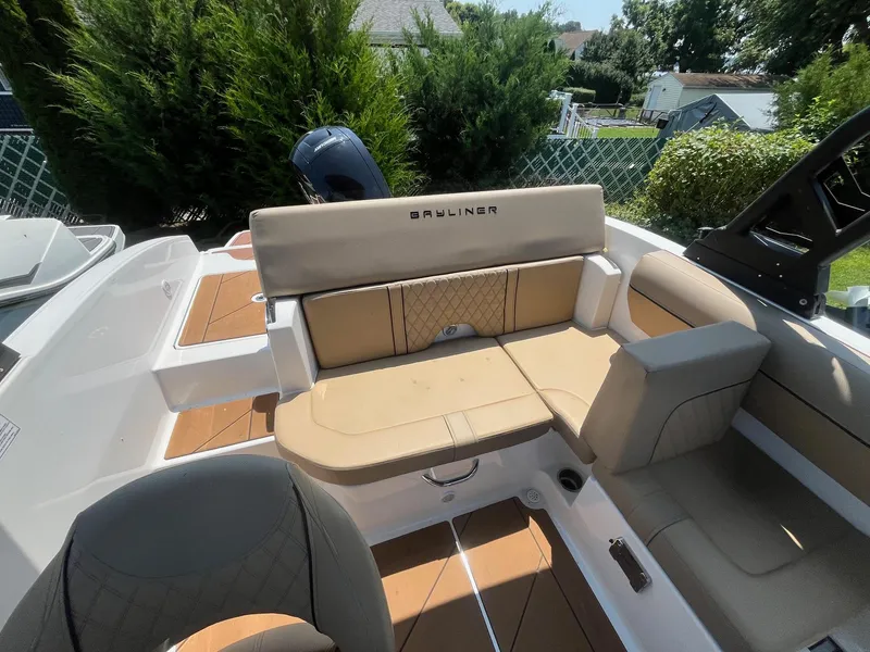 Slide: The Image of 2023 Bayliner DX 2000 boat interior with tan seating and modern design. - 7
