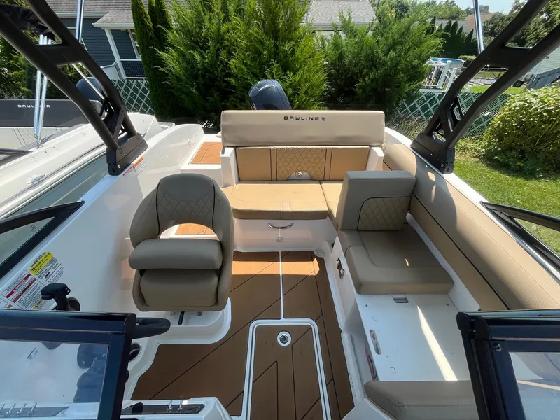 Slide: The Image of 2023 Bayliner DX 2000 boat interior with beige seating and modern design. - 8