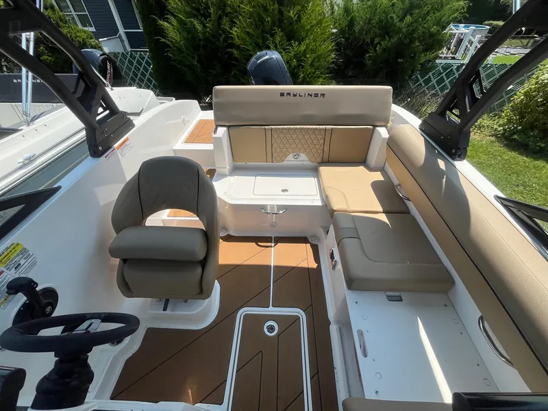 Slide: The Image of 2023 Bayliner DX 2000 boat interior with seating and steering wheel. - 9