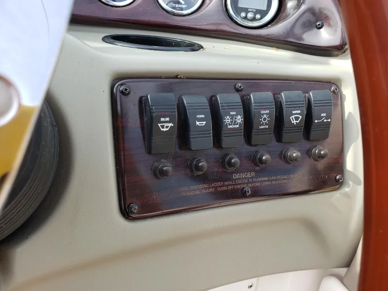 Slide: The Image of Control panel of a 1999 Chaparral 2335 SS boat with labeled switches. - 10