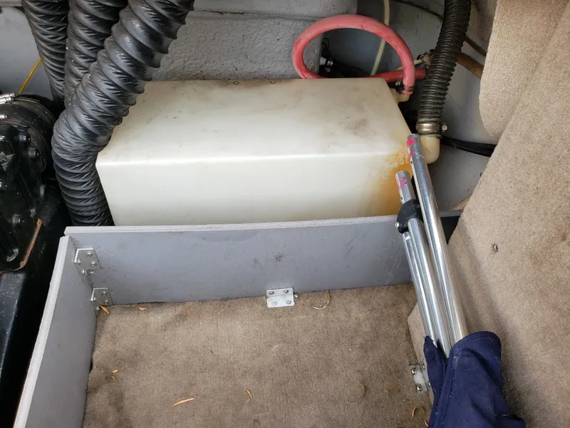 Slide: The Image of Interior of a 1999 Chaparral 2335 SS boat showing storage compartment and equipment. - 14