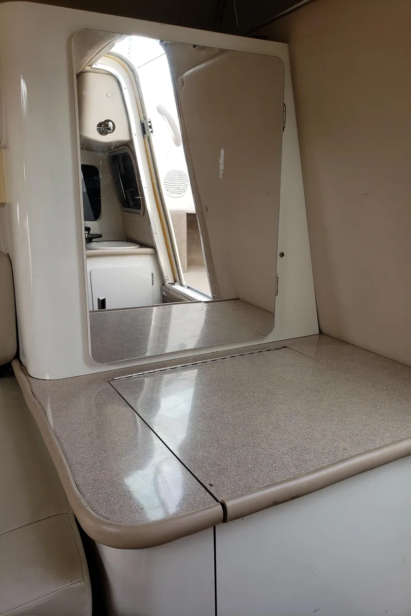 Slide: The Image of Interior of 1999 Chaparral 2335 SS boat, featuring a compact cabin space. - 15