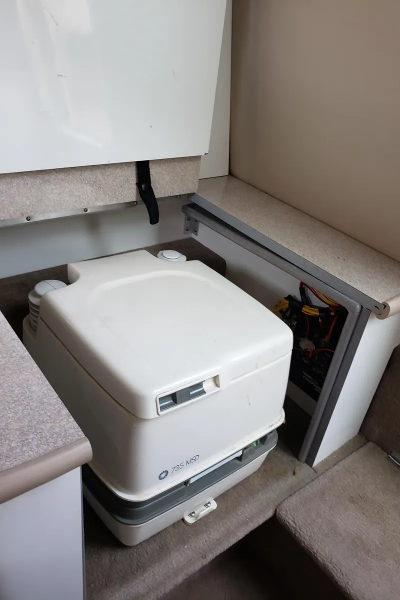 Slide: The Image of Portable toilet inside 1999 Chaparral 2335 SS boat cabin. - 16