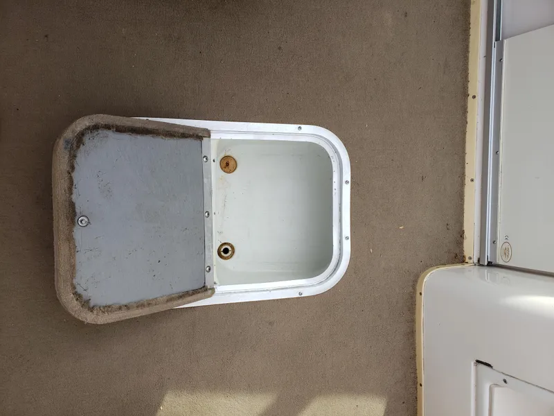 Slide: The Image of Open storage compartment on 1999 Chaparral 2335 SS boat deck. - 18