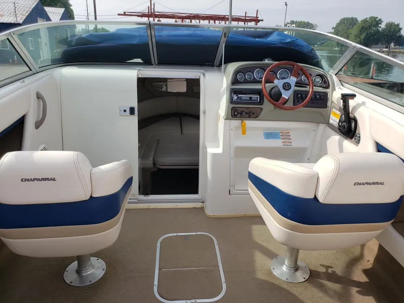 Slide: The Image of 1999 Chaparral 2335 SS boat interior with steering wheel and seating. - 3