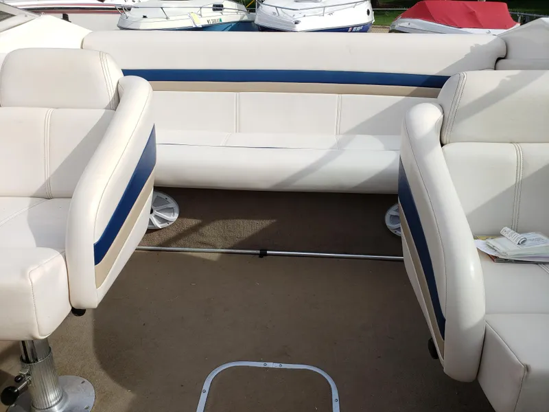 Slide: The Image of 1999 Chaparral 2335 SS boat interior with white and blue seating. - 4