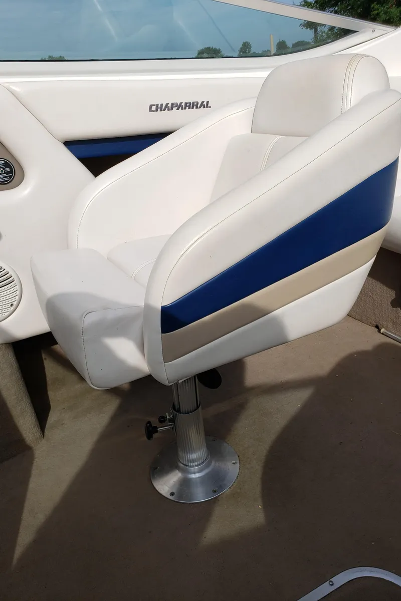 Slide: The Image of 1999 Chaparral 2335 SS boat interior with white and blue seating. - 5