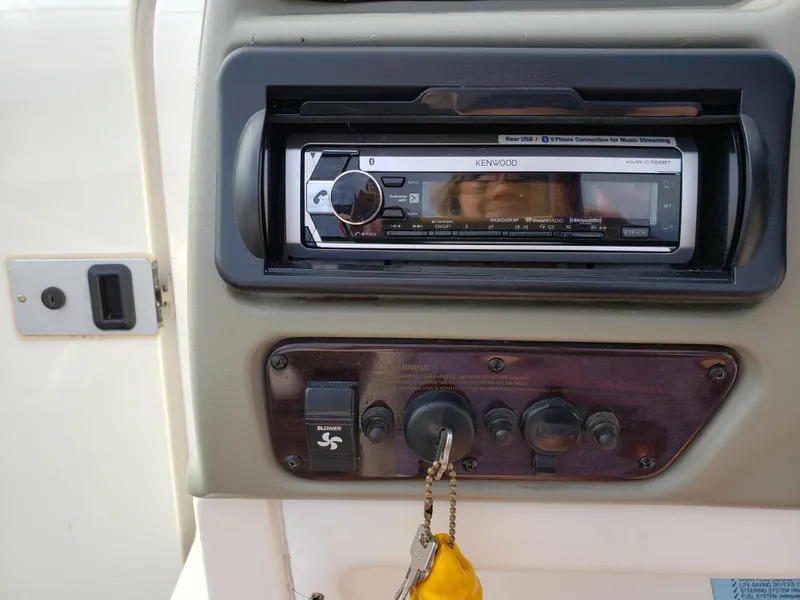 Slide: The Image of 1999 Chaparral 2335 SS boat dashboard with Kenwood stereo and blower switch. - 7