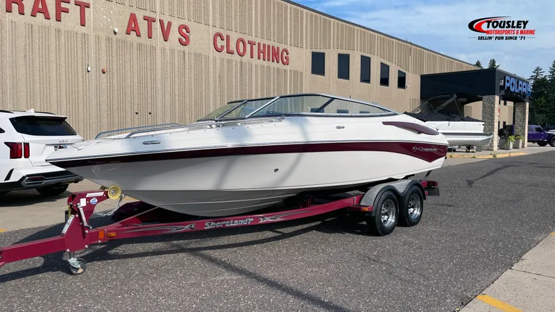 Slide: The Image of 2011 Crownline 21SS boat on a trailer outside a dealership. - 1
