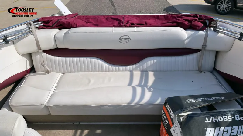 Slide: The Image of 2011 Crownline 21SS boat interior with white and maroon seating, Tousley Motorsports branding. - 5