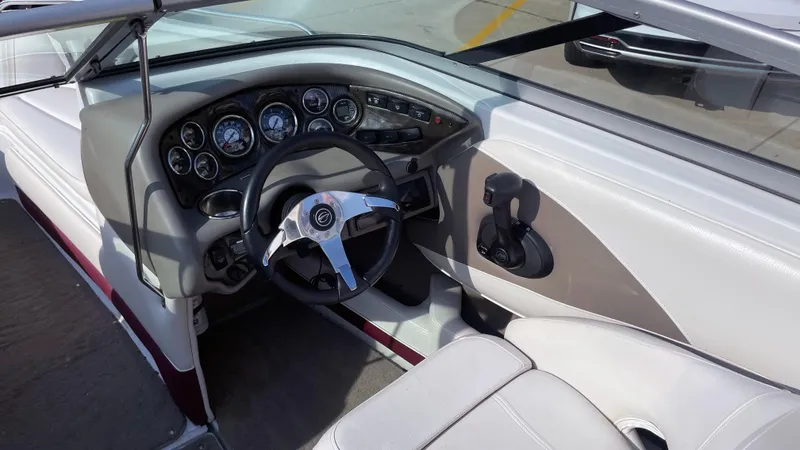 Slide: The Image of 2011 Crownline 21SS boat interior with steering wheel and dashboard controls. - 6