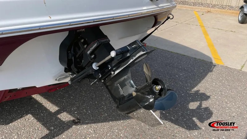 Slide: The Image of 2011 Crownline 21SS boat with MerCruiser outdrive, parked on asphalt. - 7